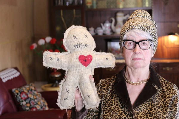 Close Portrait Mature Woman Leopard Jacket Hat Holding Voodoo Doll — Φωτογραφία Αρχείου