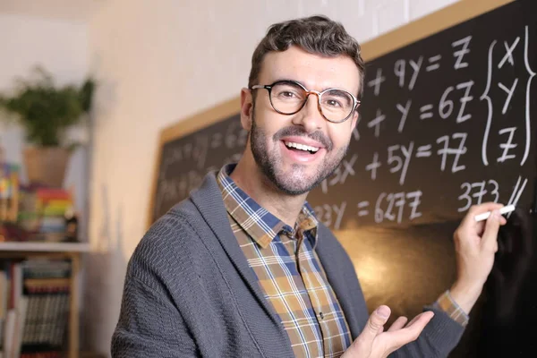 Close Portrait Handsome Young Teacher Writing Math Example Blackboard Classroom — Stock Photo, Image