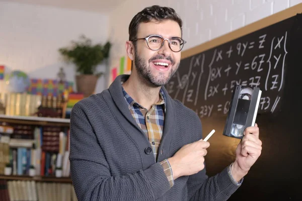 Close Portrait Handsome Young Teacher Holding Chalk Tape Video Cassette — Zdjęcie stockowe