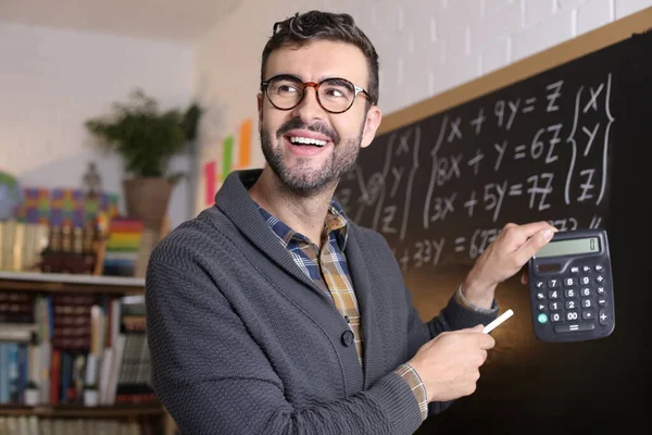 Close Portrait Handsome Young Teacher Holding Chalk Calculator Front Blackboard — Stock Photo, Image