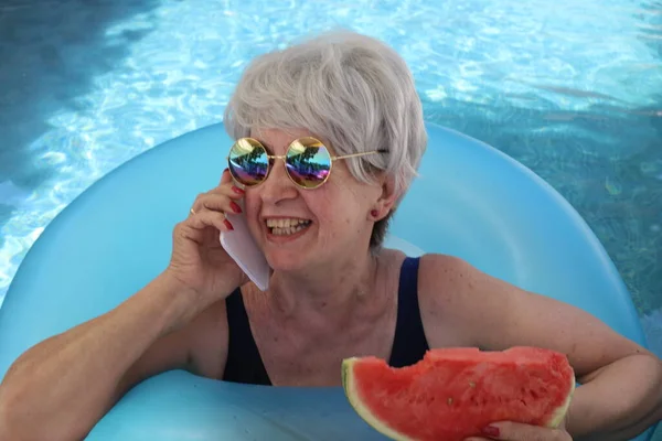 Portrait Mature Woman Swimsuit Slice Watermelon Talking Phone Pool Sunny — Stock Photo, Image
