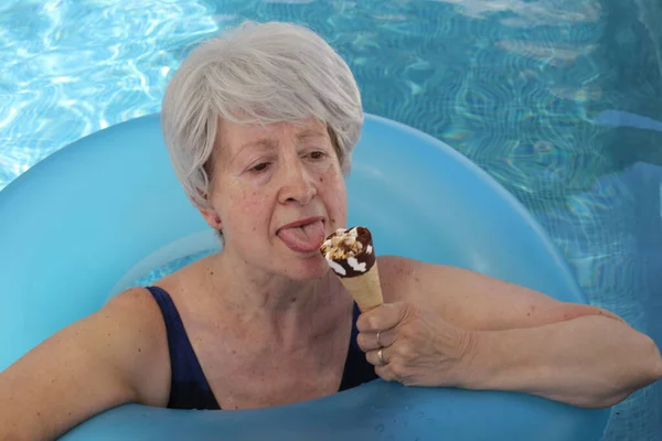 Portrait Mature Woman Swimsuit Inflatable Tube Eating Ice Cream Pool — Stock Photo, Image