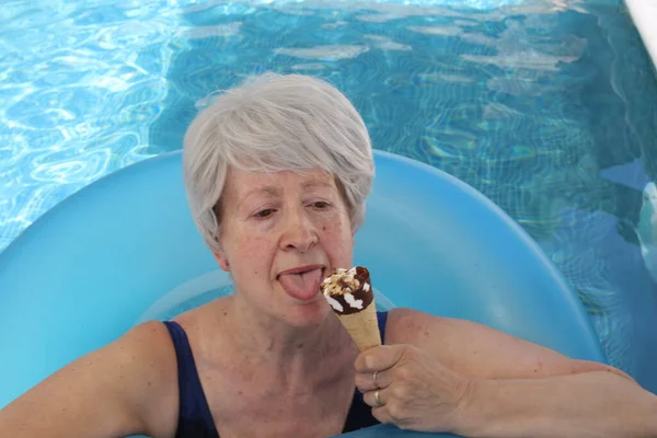 Portrait Mature Woman Swimsuit Inflatable Tube Eating Ice Cream Pool — Stock Photo, Image