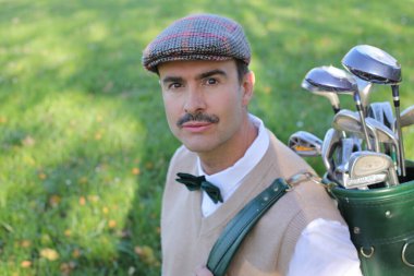 Handsome elegant golfer with mustache outdoor