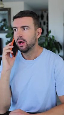 Man talking on mobile phone indoors