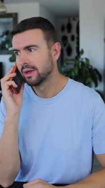 Man talking on mobile phone indoors