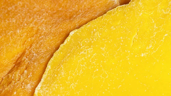 Żółte i pomarańczowe suszone plastry mango, super makro — Zdjęcie stockowe