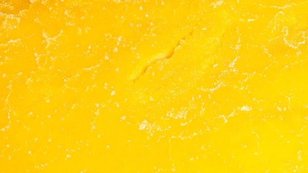 Bright yellow texture of mango jerky slice — Stock Photo, Image