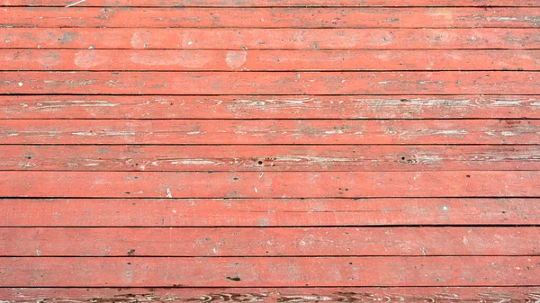 Alte verblichene Planken mit roter Farbe bemalt — Stockfoto