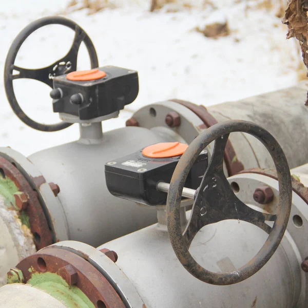 Modern black oil pipe valve wheel. Metal, pipeline and mechanic concept. An old iron valve on a gas pipe. A valve to cover the pipe with a round handle.