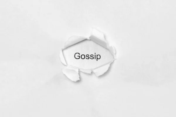 Word gossip on white isolated background through the wound hole in the paper. — Stock Photo, Image