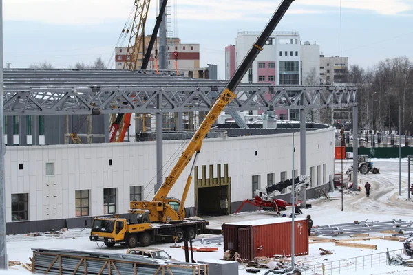 12.05.2020 Syktyvkar, Rusia, Reconstrucción de un estadio deportivo, equipos de construcción y coches durante el día en invierno —  Fotos de Stock