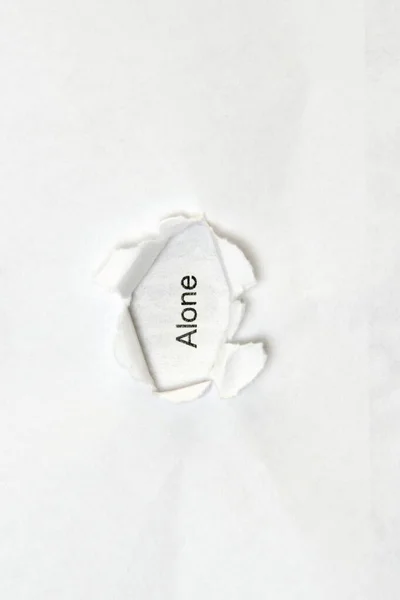 Palabra sola sobre fondo blanco aislado a través del orificio de la herida en el papel. — Foto de Stock