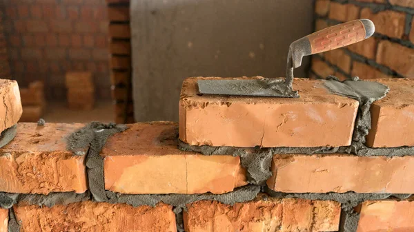 Brickwork of brick, folded in a certain way and fixed with mortar. industrial brick placing brick on cement in the construction of external walls, industry details