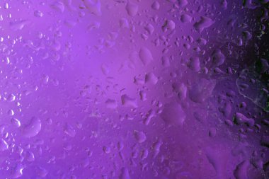 Abstract background with water drops on purple background