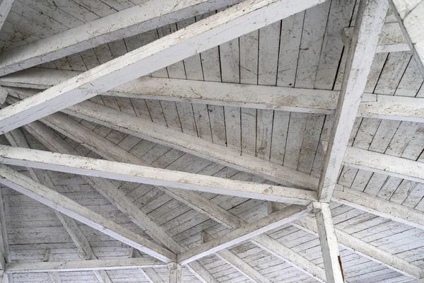 Wooden structure of a complex, tapered roof. Wood processing