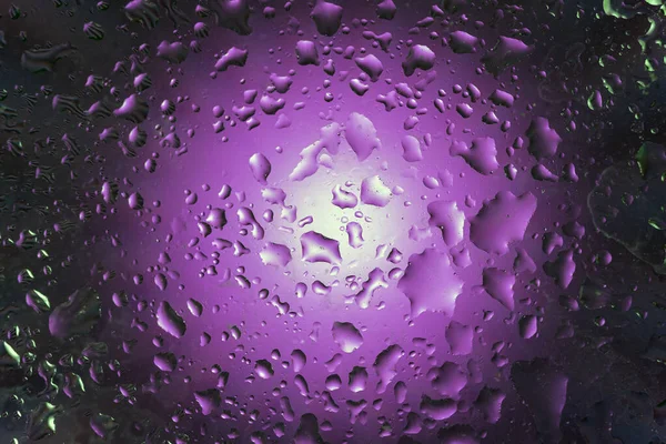 Abstract background with water drops on purple background