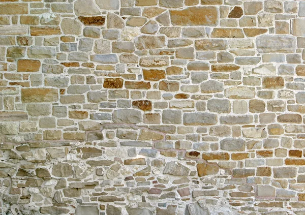 Gamla väggen med många små och stora stenar — Stockfoto