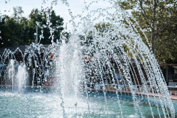 stock image fountain in the street of a small town. Splashes of fountain water in a sunny day. beautiful place to get rest and relax. 