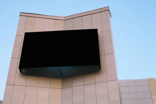 giant outdoor screen for advertising and commercials. big empty black digital billboard screen on the building, mock up for your design. streeet commercials.