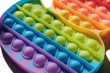 Pop It fidget toy. antistress toy, pop silicone bubbles, relax and leisure game, children and kids favorite rainbow color game. duck shaped isolated on white background. close up view