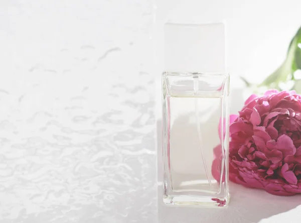 Blumen Parfümflasche Neben Pfingstrose Blume Und Glas Strukturierte Tür Badezimmer — Stockfoto