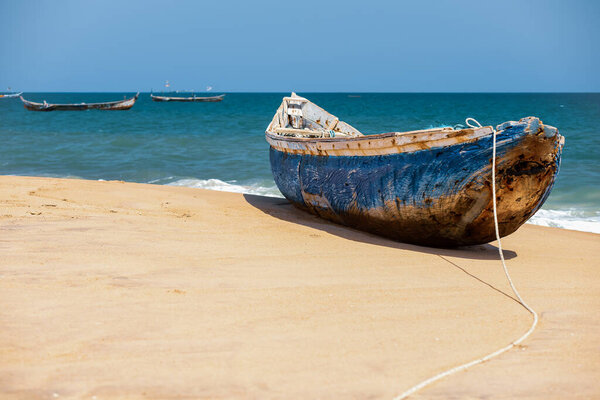 A blue painted African fishing boat on a beach in Keta Ghana West Africa