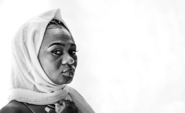 Afrikalı Gana 'lı kadın saçını beyaz bir şalla örtüyor.