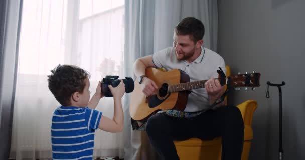 Little son, filming and posing for the blog as my father plays the guitar. — Αρχείο Βίντεο