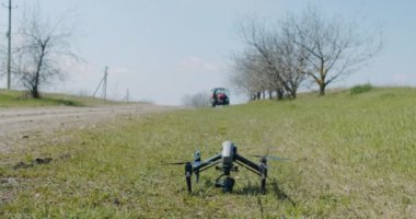  Modern, askeri insansız hava aracı, çimlere iniyor, kalkmayı bekliyor.