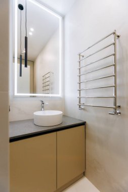 A sleek and modern bathroom that showcases a minimalist design, elegant fixtures, and stylish decor elements