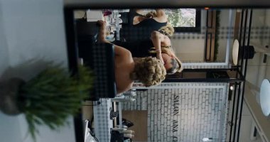 A glimpse inside a chic salon where women are preparing for a special event, focusing on beauty and elegance.