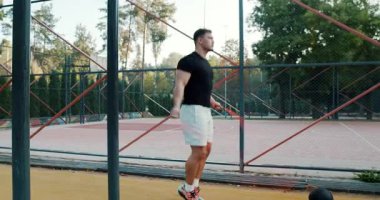 An energetic person does a jump rope workout outdoors, showcasing their fitness and dedication to health