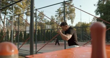 An athlete is engaged in a rigorous outdoor exercise routine to significantly improve fitness and strength