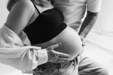 Destekleyici partneri olan bir çocuk bekleyen kadın, sakin bir sabah boyunca partnerinin nazikçe tuttuğu hamile kadın.