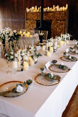 Charming environment enhanced by candles greenery, Refined rustic aesthetic complemented by floral accents and soft