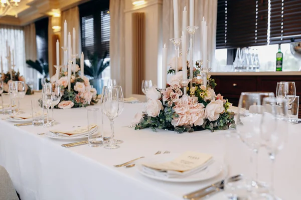 Charming floral arrangement with ambient lighting, Beautiful flower display highlighted by gentle candle glow ambiance