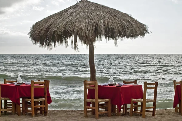 Ombrellone e tavoli in riva al mare — Foto Stock