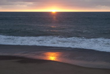  Batan güneşin bir okyanus kıyısında