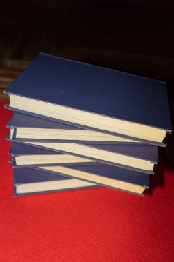 Eski kitaplar üst üste istiflenir. Bir yığın kitap. Eski kitapların omurgaları.