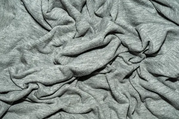 生地は灰色で折り目が多い 縮れ綿のTシャツ生地 — ストック写真