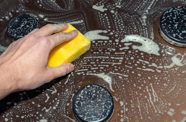 Hob 'u temizlemek ve yıkamak. Gaz sobasından yağ çıkarmak. Yağları temizlemek için sünger ve köpüklü el..