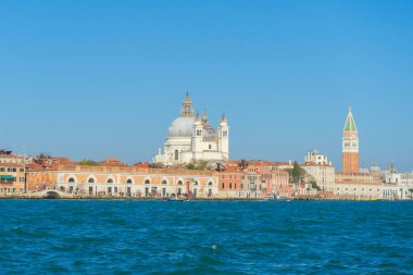 Venedik, İtalya - 10.11.2024: Basilica di Santa Maria della Salute ve St. Mark 's Campanile' in Venedik Gölünün karşısındaki panoramik manzarası, İtalya.