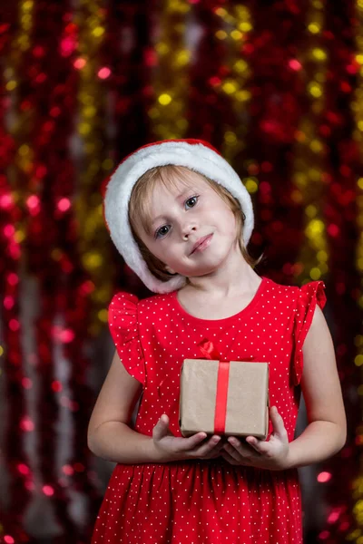 Adorable Little Girl Santa Hat Holding New Year Present Dreaming — Stock Photo, Image