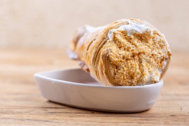 Protein kremalı ya da ahşap masadaki kremalı leziz puf böreği.