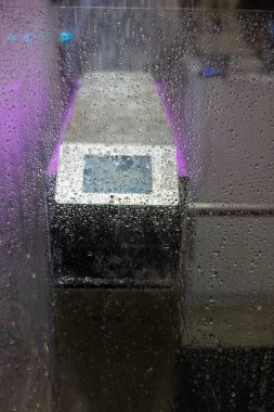 Bir sergide sürekli su ya da yağmur altında çalışan bir turnikedir.