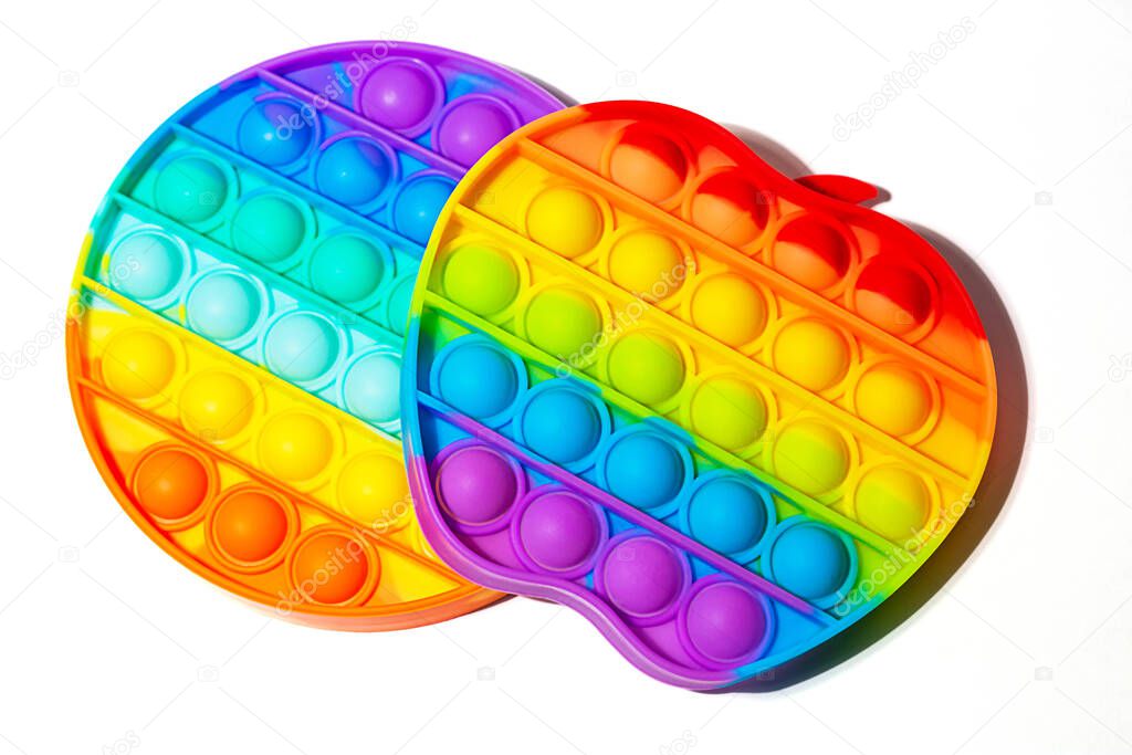 Top view of the sensory toy pop it on white background.Rainbow color.Good as banner with copy space.Antistress toy for children and adult.