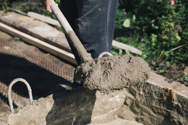 Cementing garden paths on top of metal mesh, construction work in the garden.