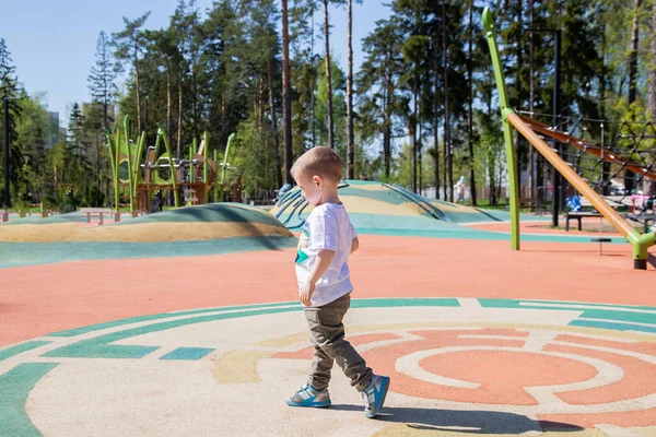 Caucasiano Menino Caminha Através Território Playground Livre Dia Ensolarado — Fotografia de Stock