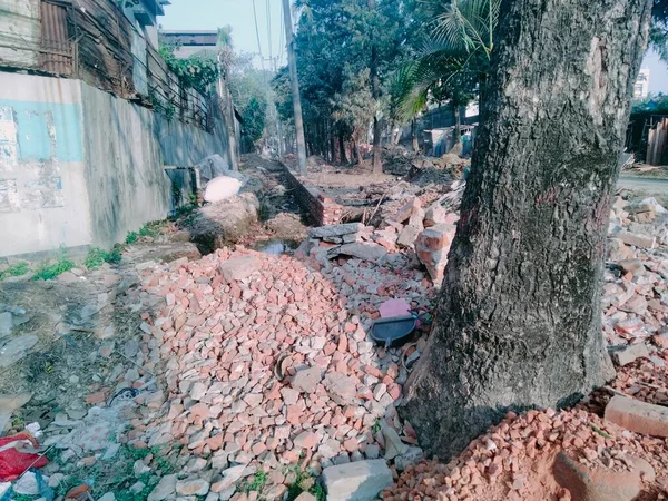 Gluing bricks to roads is so today - weve moved on to cement. Worker is destroying old bricks